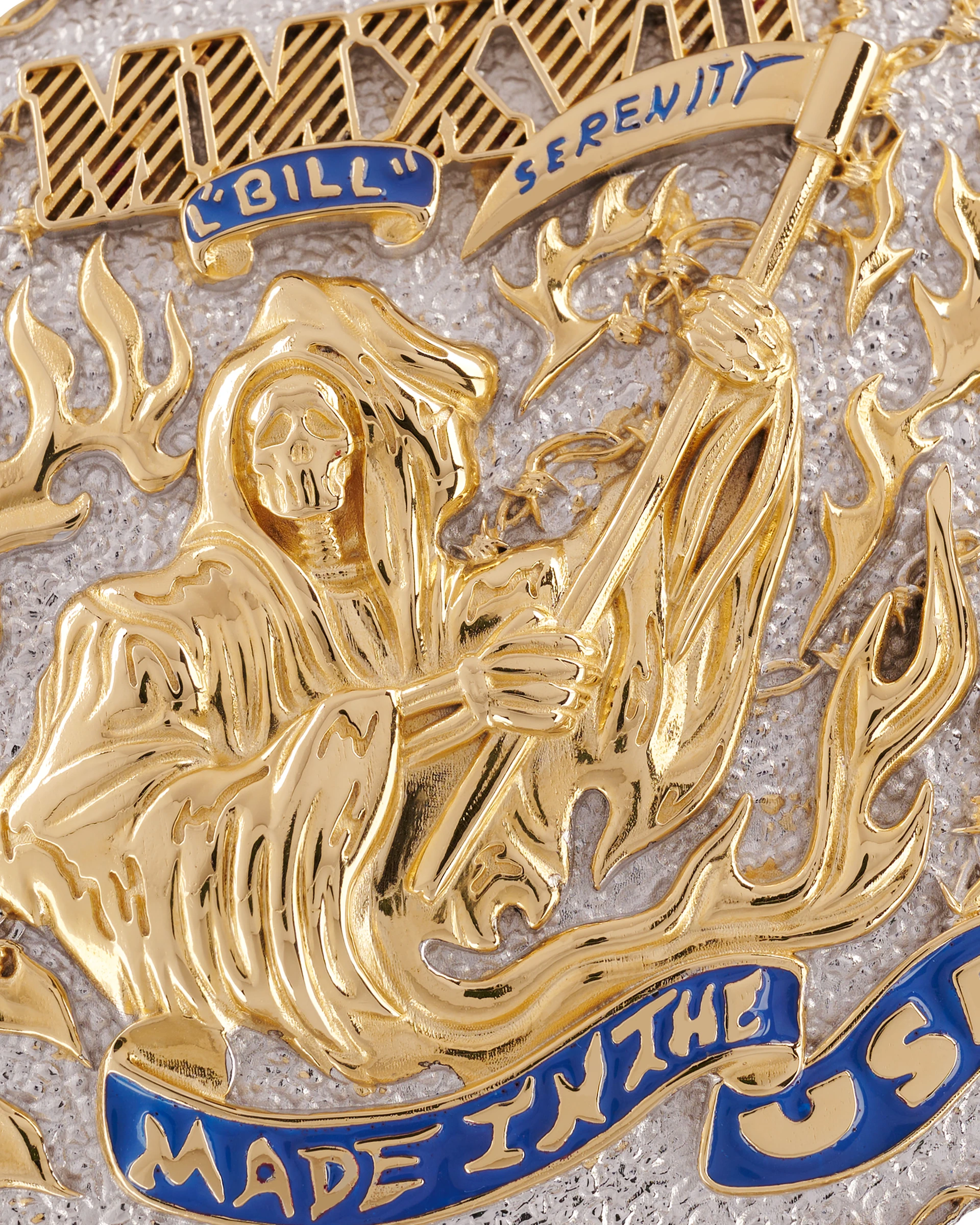 Close-up of engraved gold and silver details on the Warren Lotas belt buckle